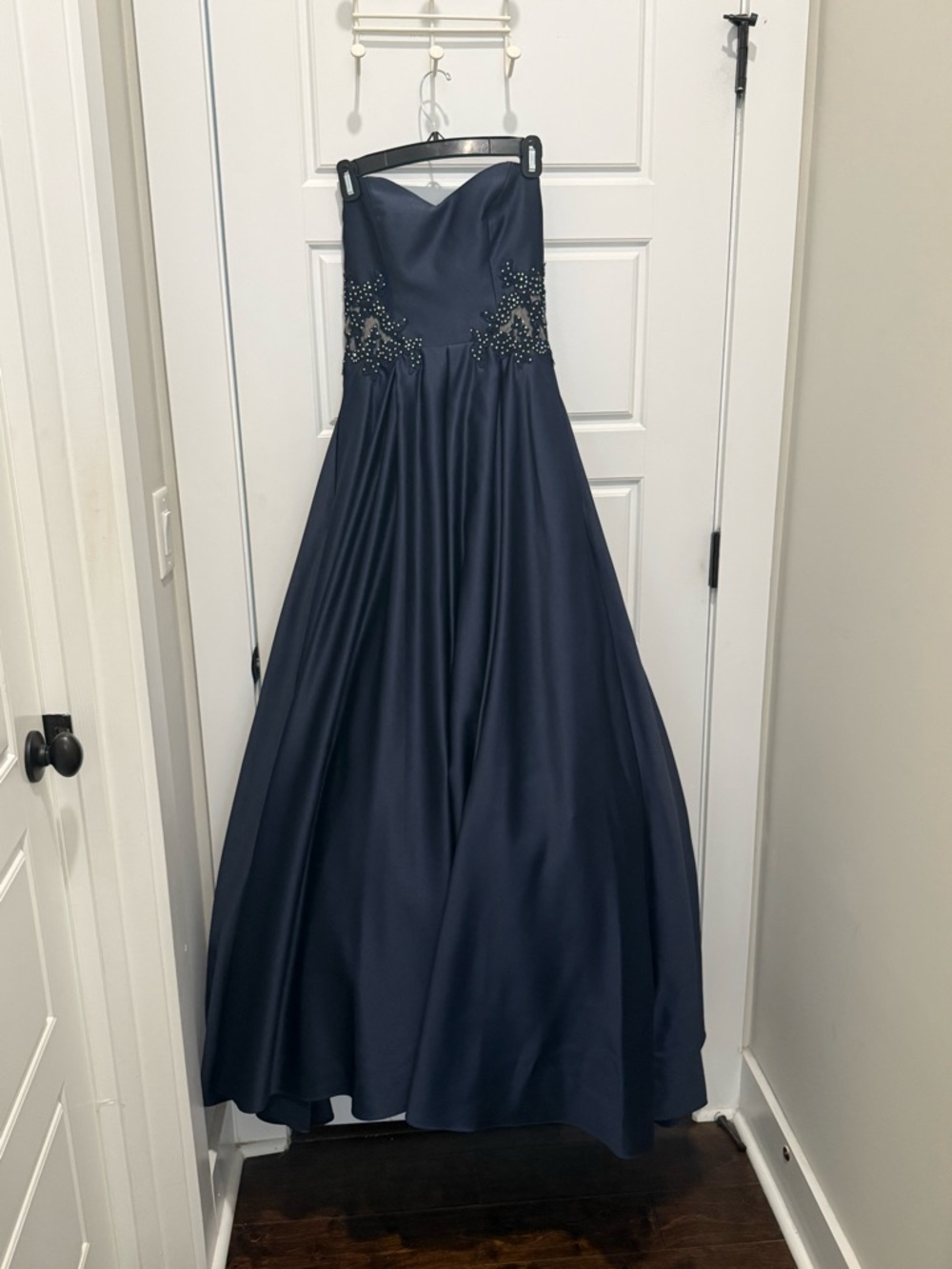 Navy sweetheart strapless tulle dress with pockets.